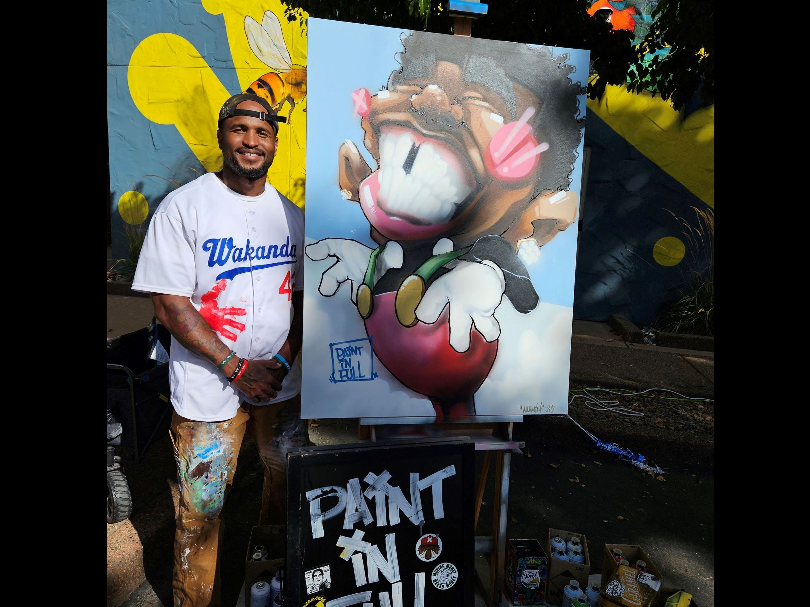 A man stands next to his art.