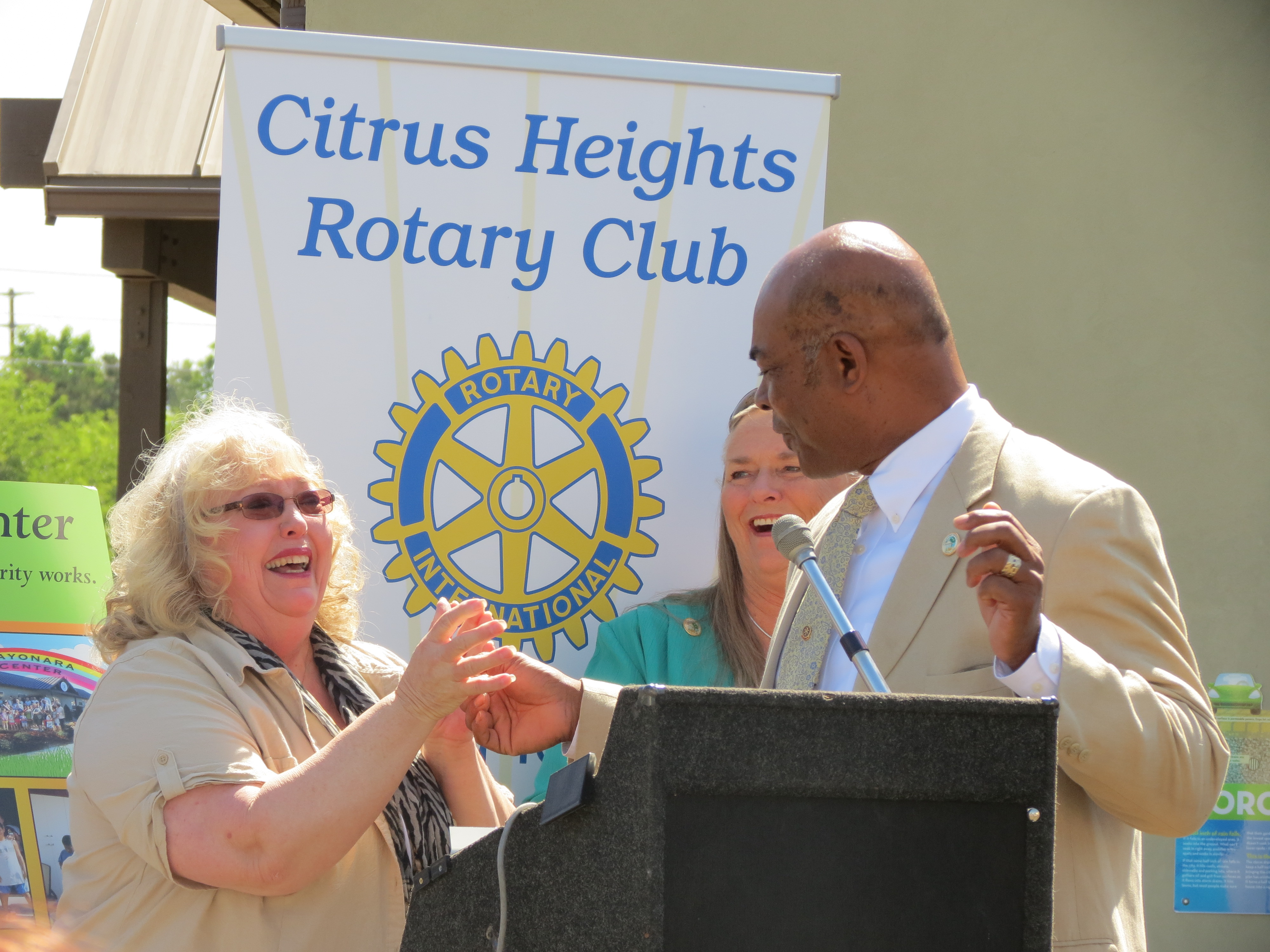 Mayor Turner giving Ms. Gladys an appreciation pin
