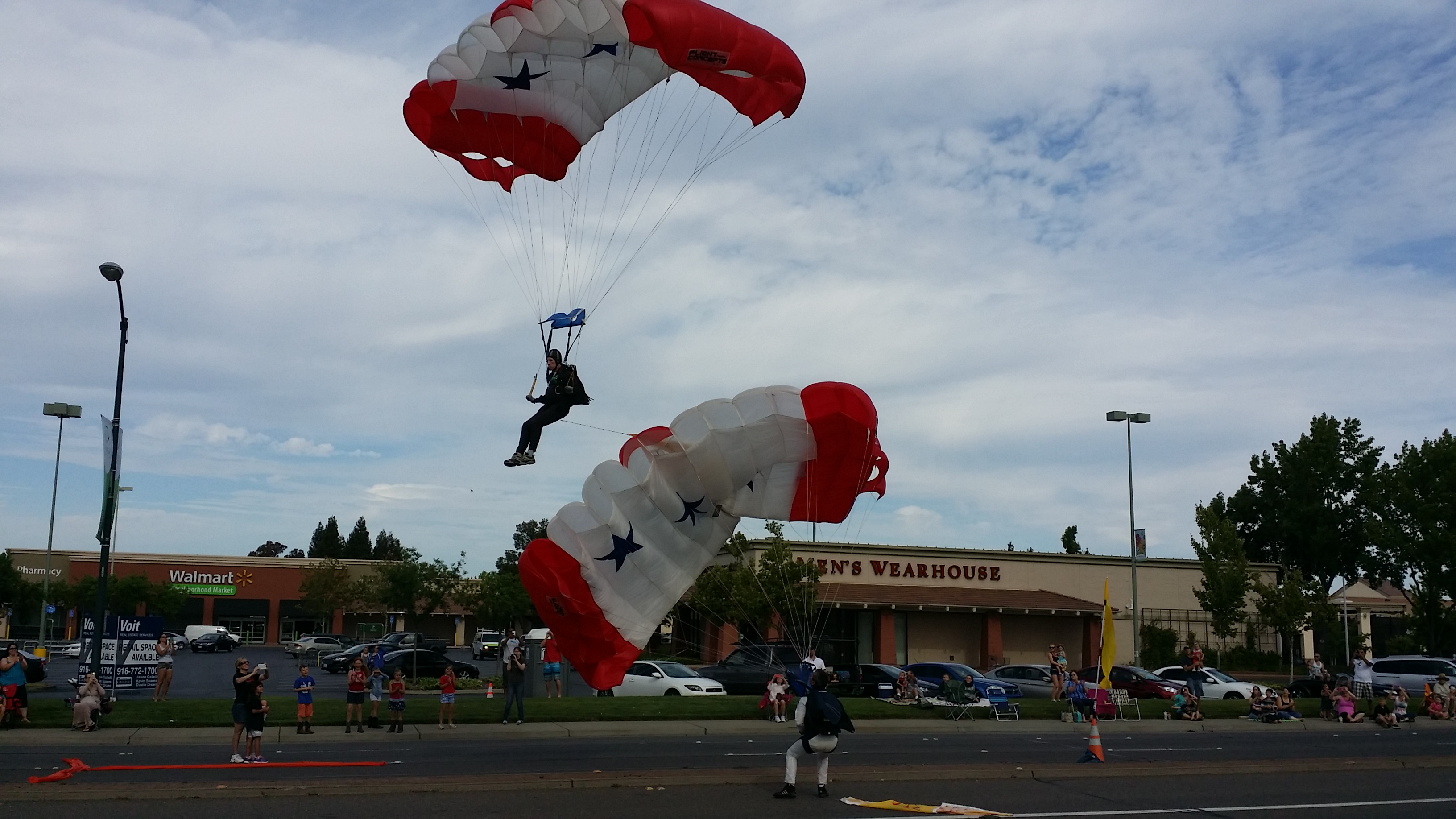 Skydivers as they land in front of Sunrise Mall